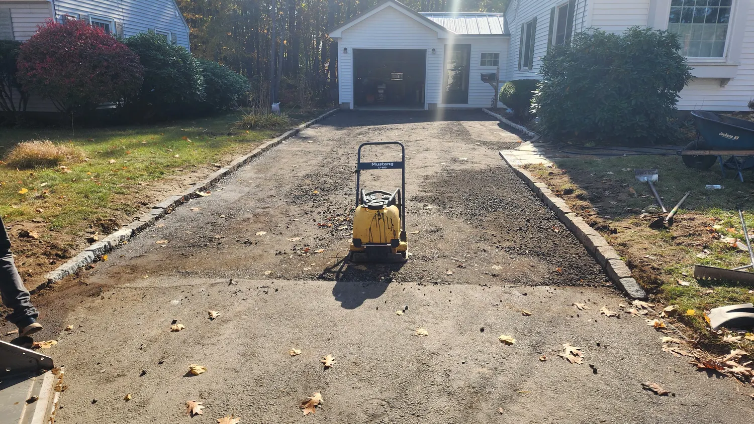 Compacting the gravel base before paving