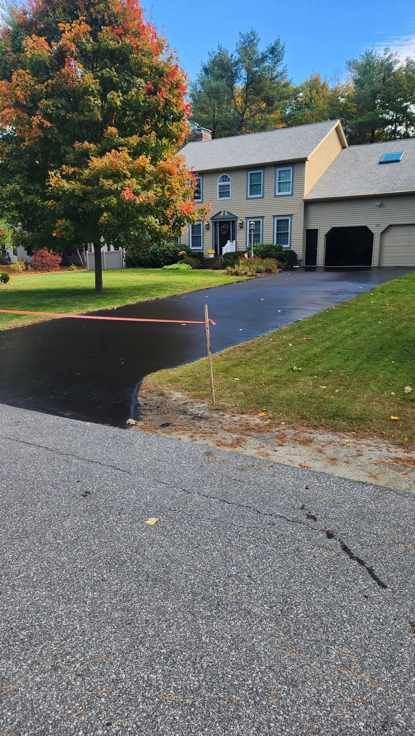 Sealcoated driveway at a colonial home in fall
